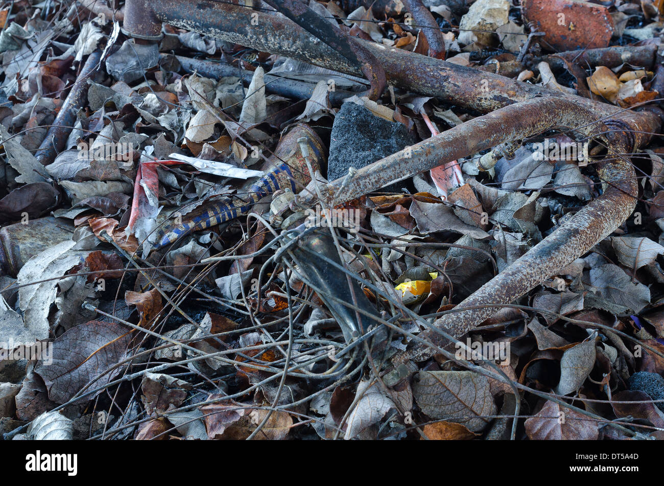 Burnt charred remains of a rusty steel and aluminum bicycle frame with