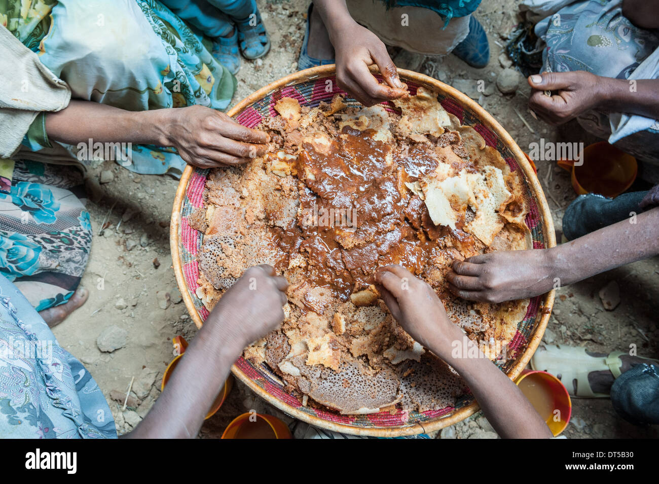 Hands of people sharing a traditional dish during a wedding celebration, Gheralta, Tigray, Ethiopia, Africa Stock Photo