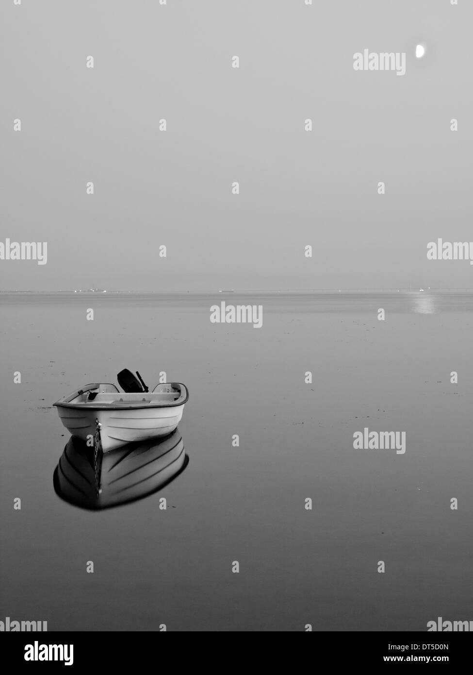 A black and white photo of a lonely boat moored offshore Bjärred, Sweden. Stock Photo