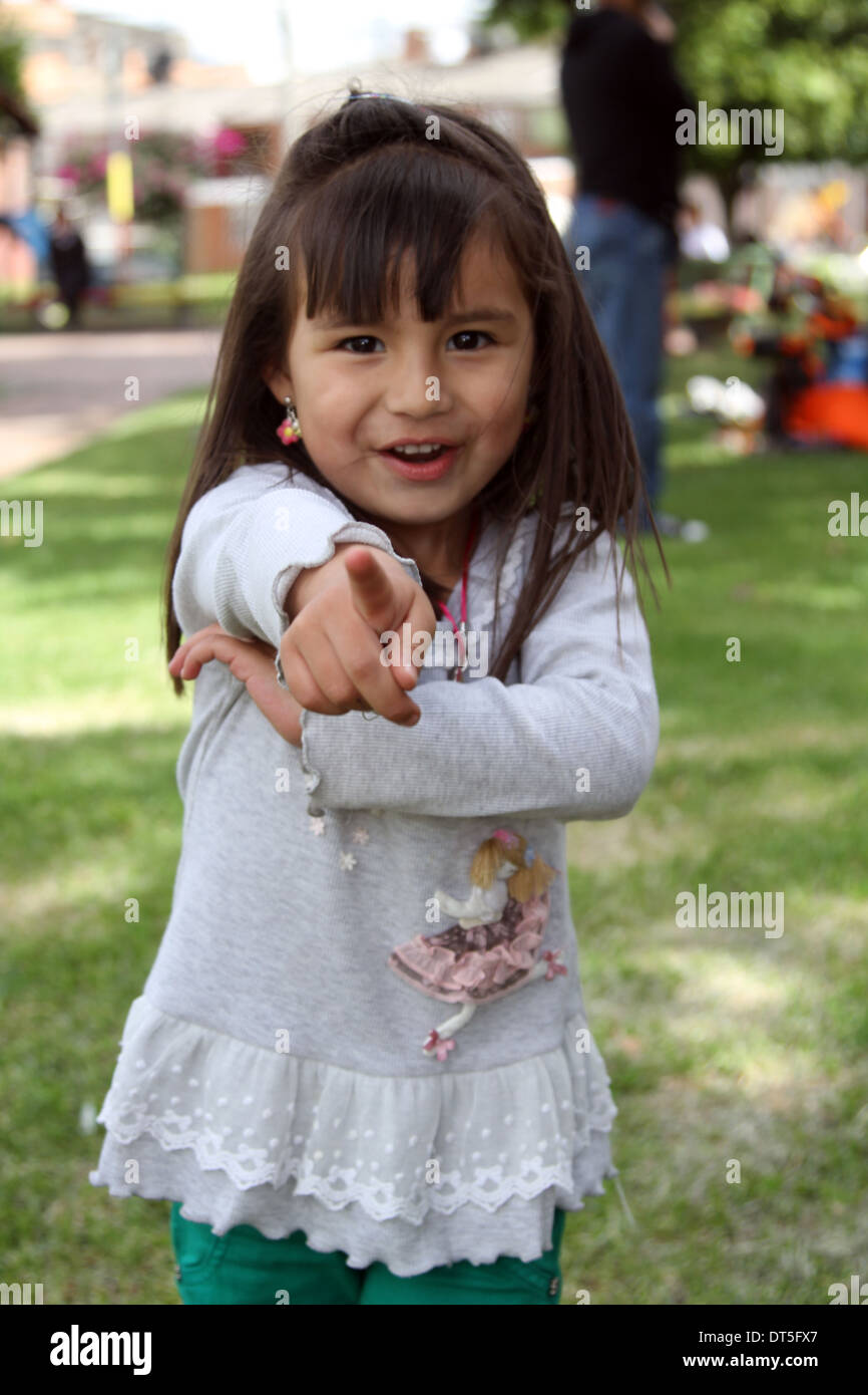Pretty young girl points Stock Photo