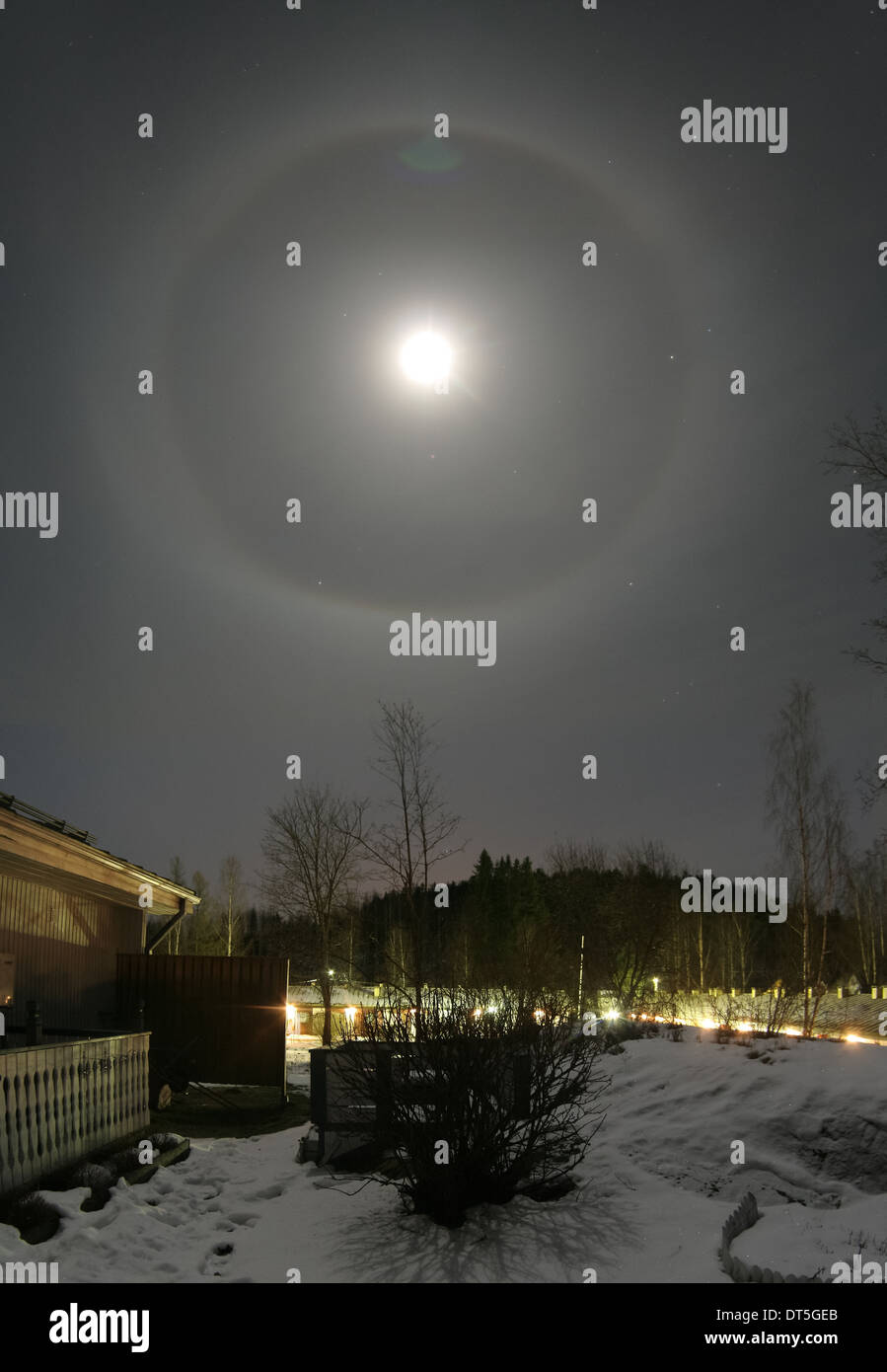 22 degree halo and moon Stock Photo