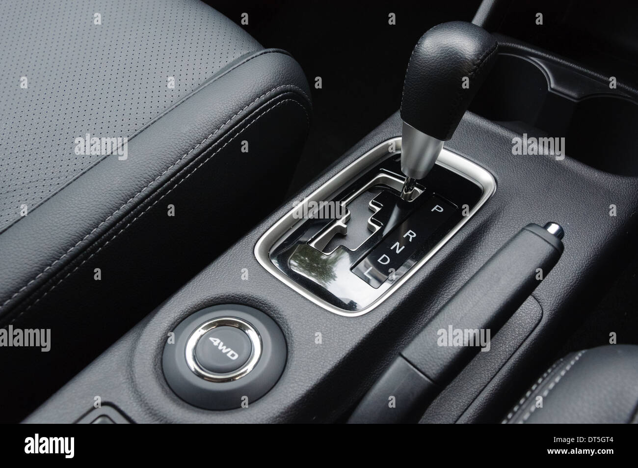 Centre console of an automatic 4x4 4 wheel drive car with a view through  the windscreen to a country road Stock Photo - Alamy