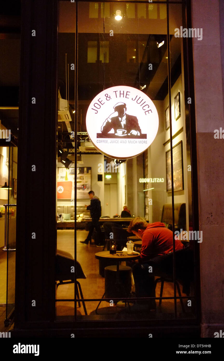 Joe & the Juice bar in London, with young man sitting at window with