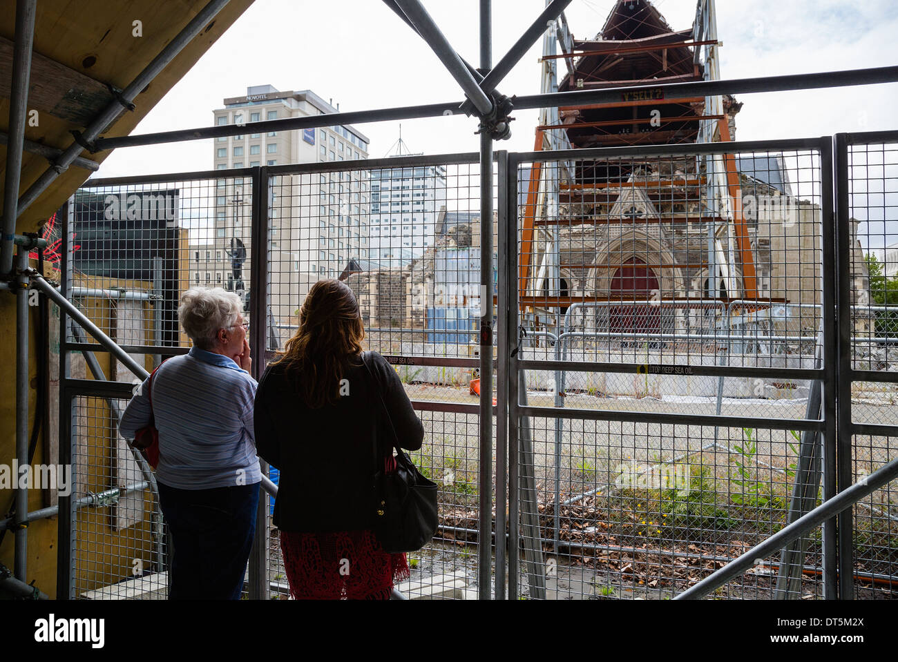 February 2014. Local people look at the ruins of the Christchurch Cathedral damaged in February 2011 earthquake. New Zealand. Stock Photo
