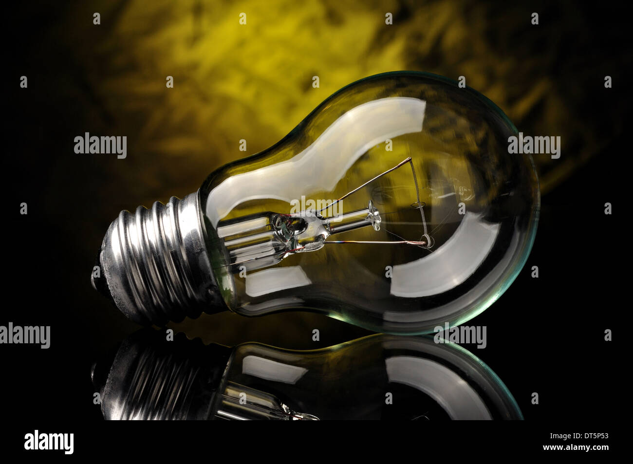 Light bulb on black yellow background Stock Photo