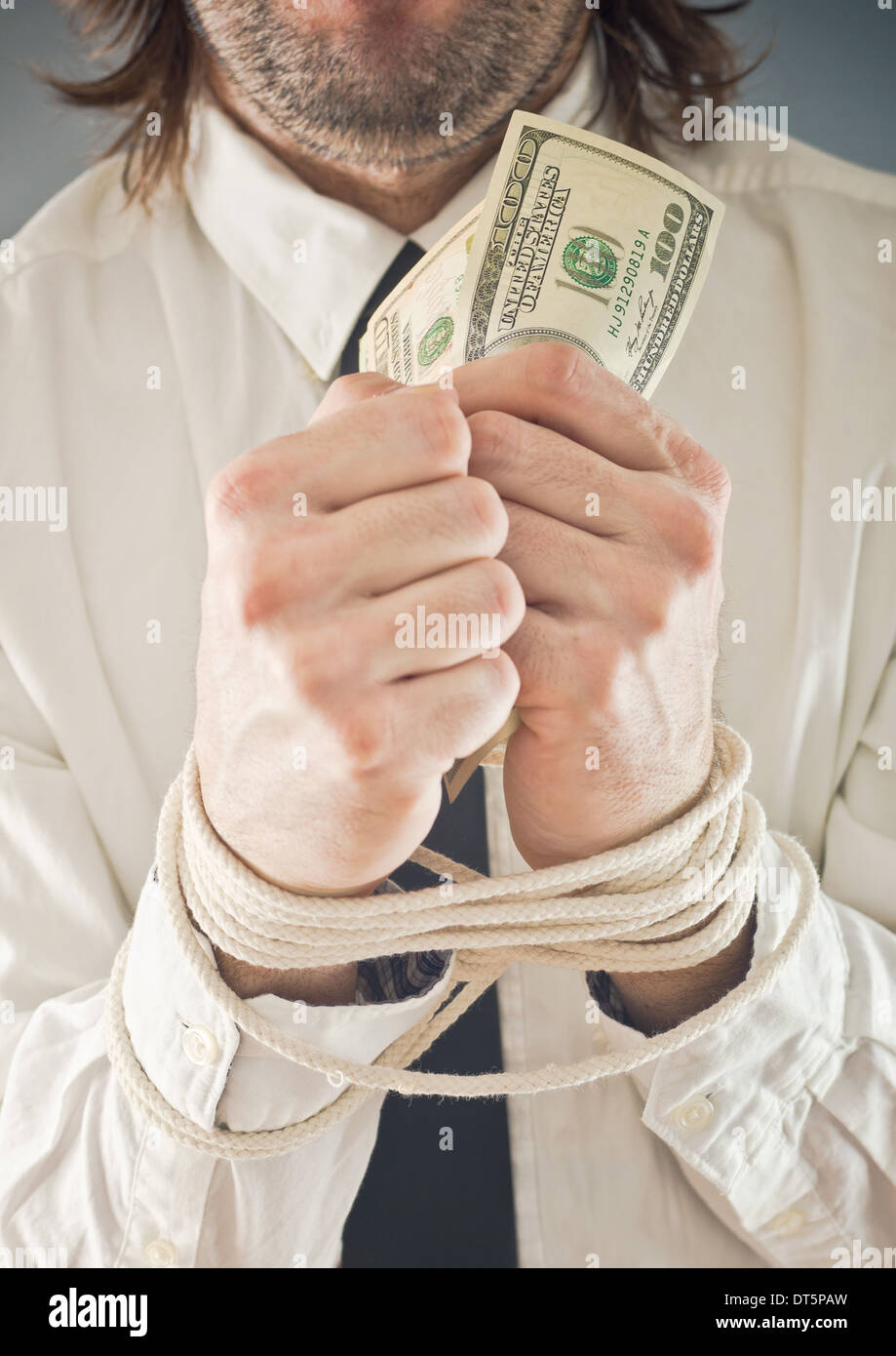 Businessman with hands tied in ropes. Business problems and difficulties, obstructions and limits in work. Stock Photo