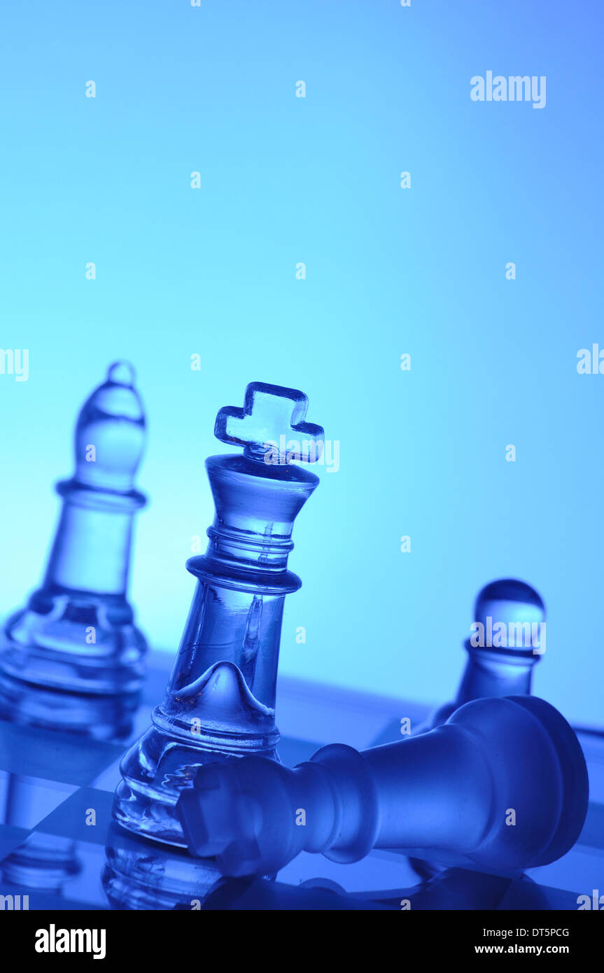 Glass chess on blue background Stock Photo