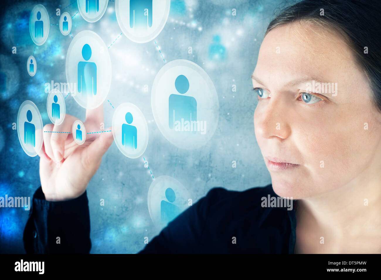 Businesswoman pressing display button on social networking scheme. Concept of modern communication through social networks. Stock Photo