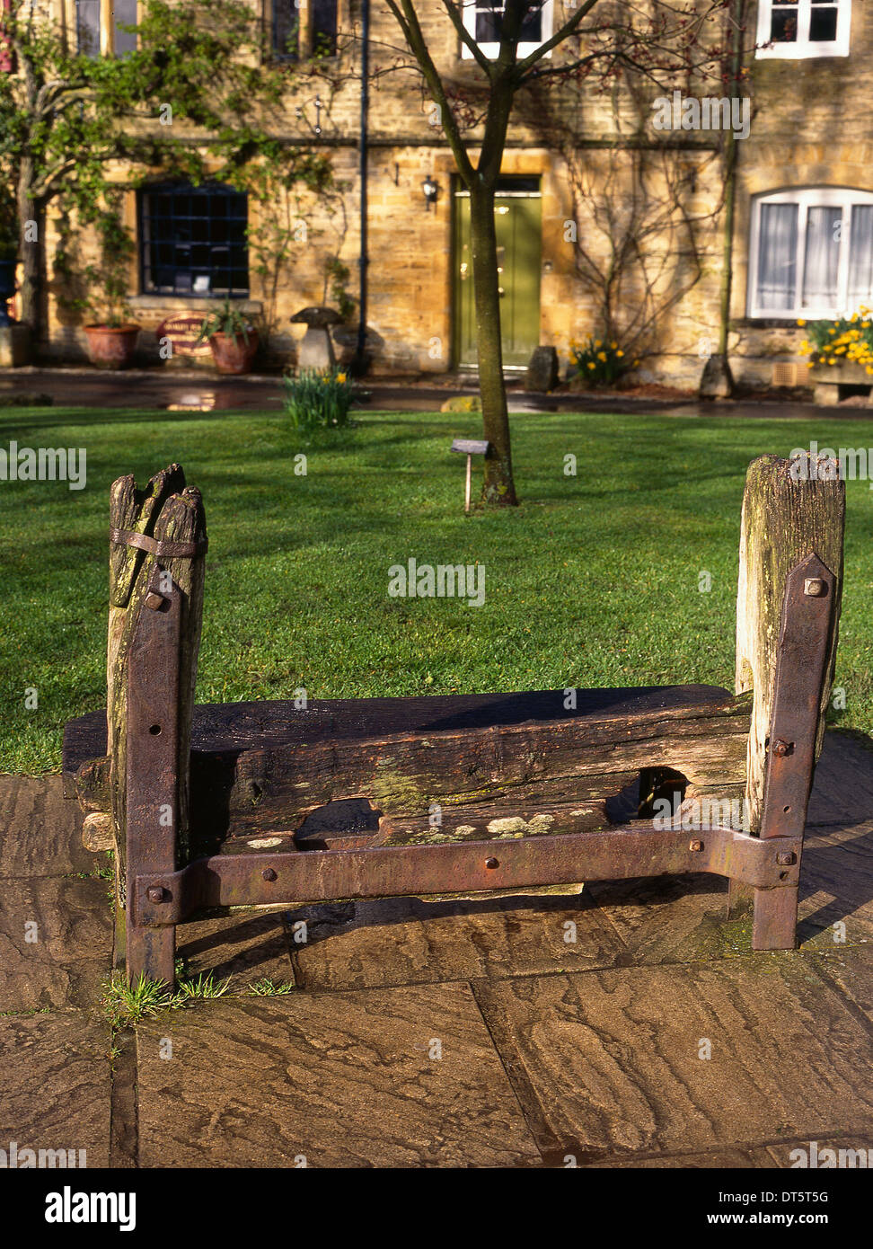 Traditional wooden stocks for punishing criminals. Village. Stow-on-the-wold, Gloucestershire, England Stock Photo