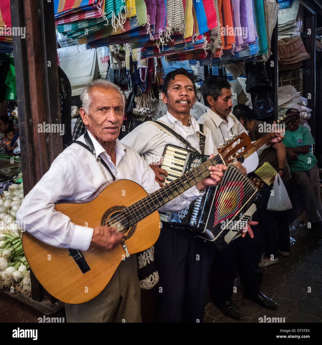 Musicians entertain shoppers in Antigua market, Guatemala Stock Photo