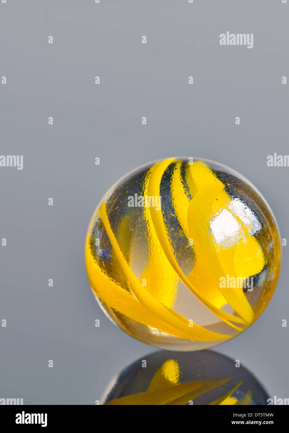 single yellow glass marble isolated Stock Photo - Alamy
