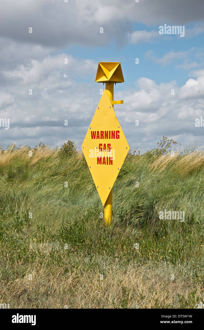 Warning gas main sign near Tilbury Power station at East Tilbury in Essex, UK Stock Photo