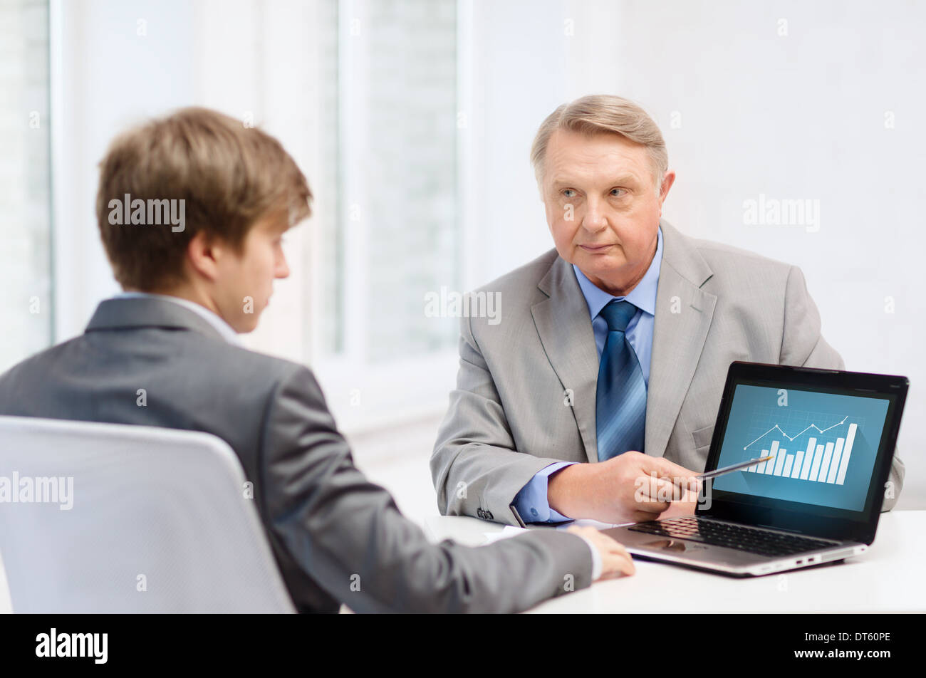 older man and young man with laptop computer Stock Photo