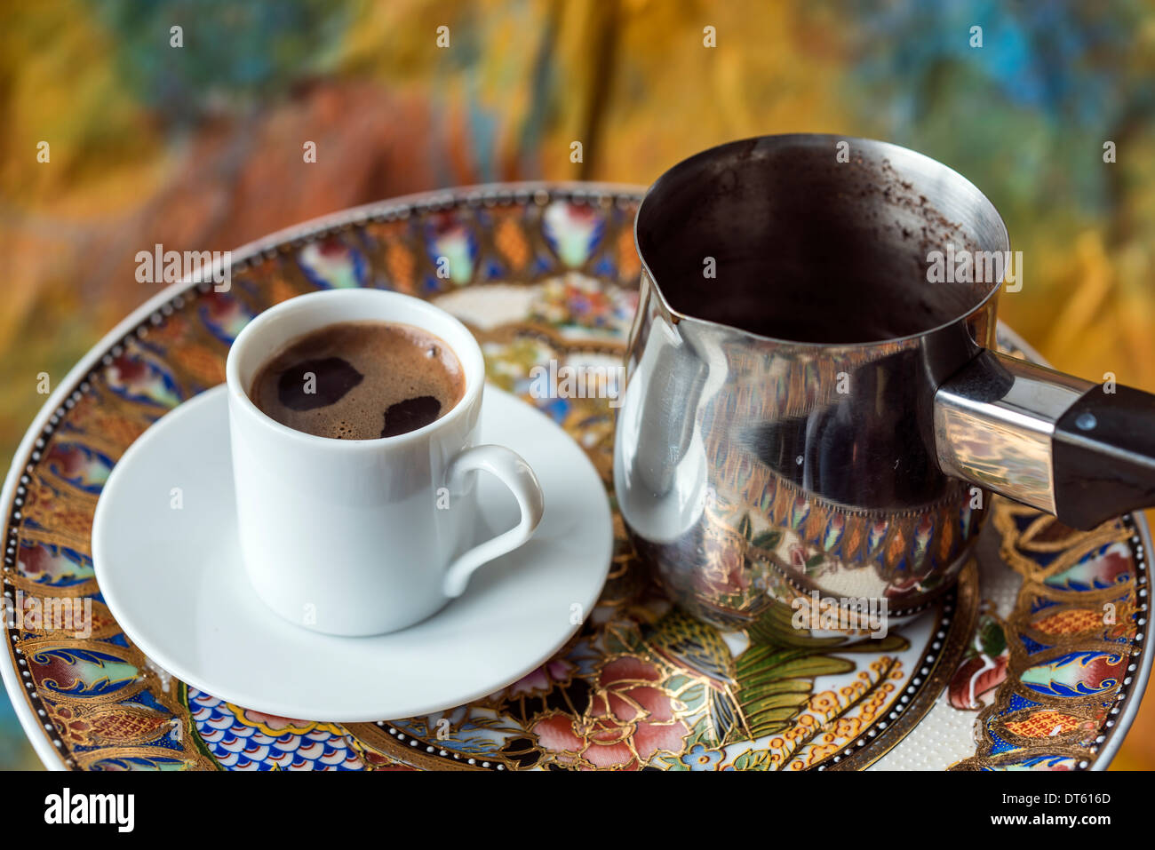 person pouring coffee from turka into a coffee cup Stock Photo - Alamy