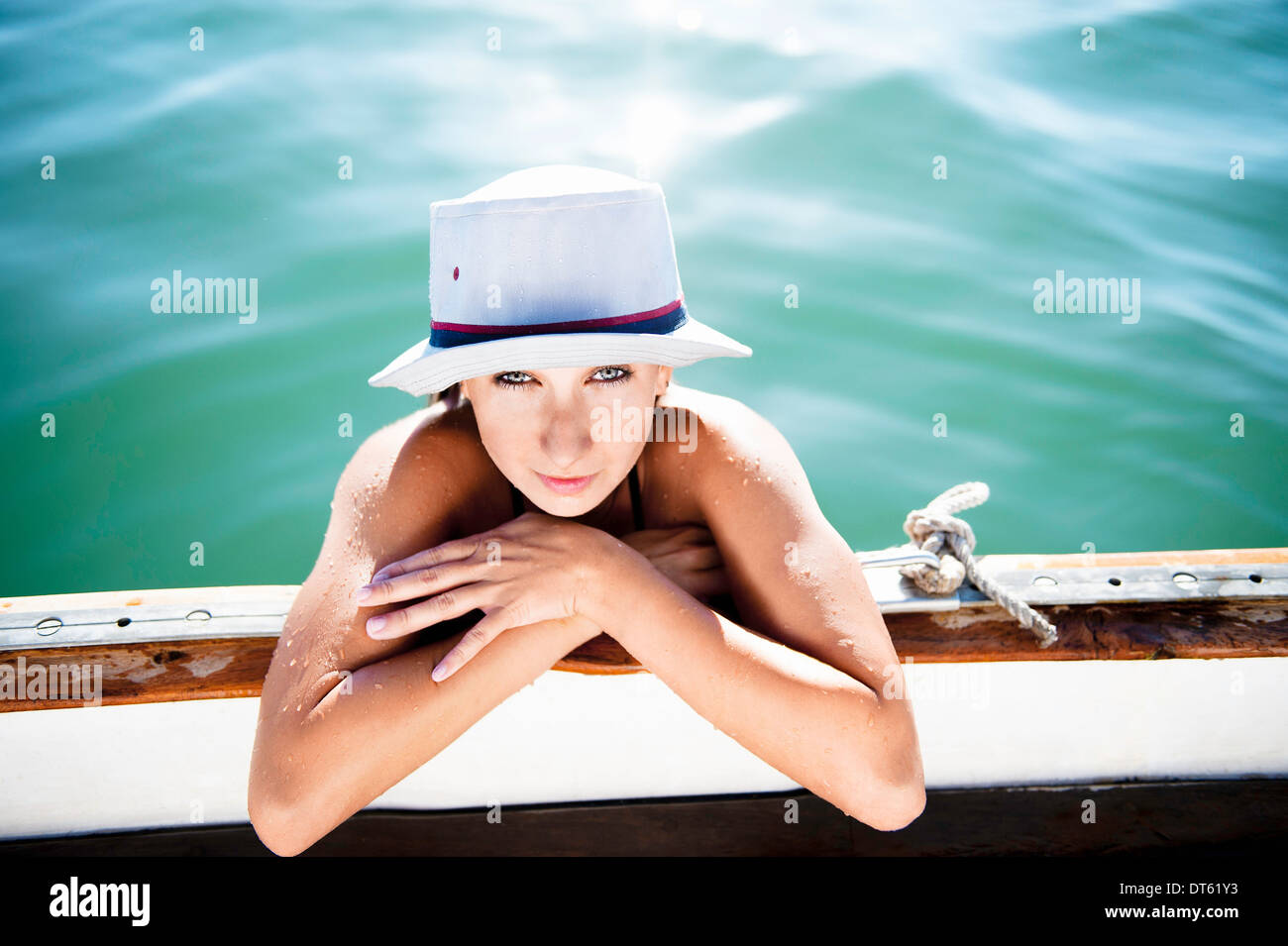 Young woman holding onto boat, Islamorada, Florida Keys, USA Stock Photo