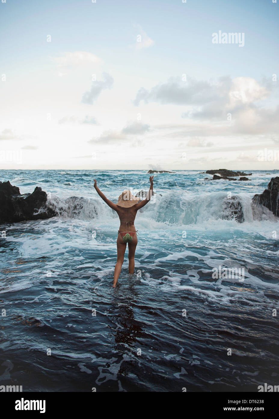 Young woman paddling in sea, Hana, Maui, Hawaii Stock Photo