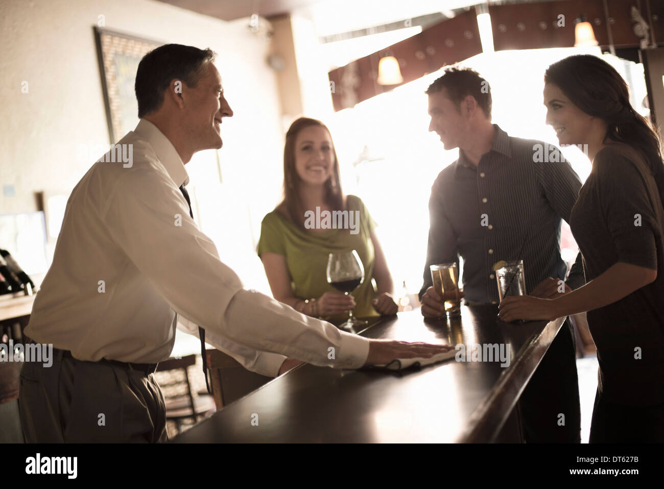 Friends enjoying a drink in wine bar Stock Photo