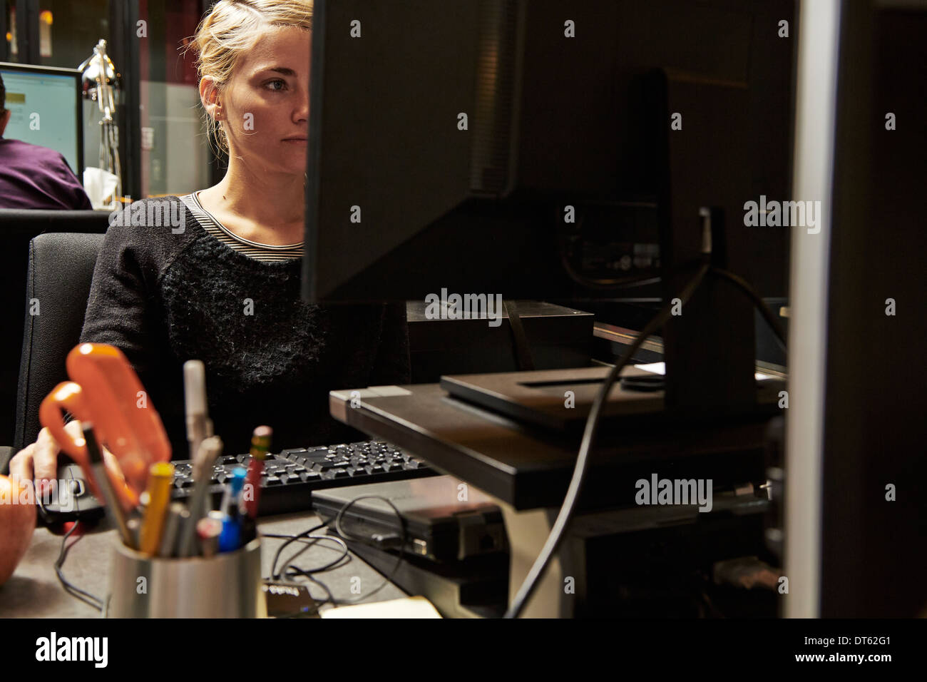 Mid adult woman using computer Stock Photo