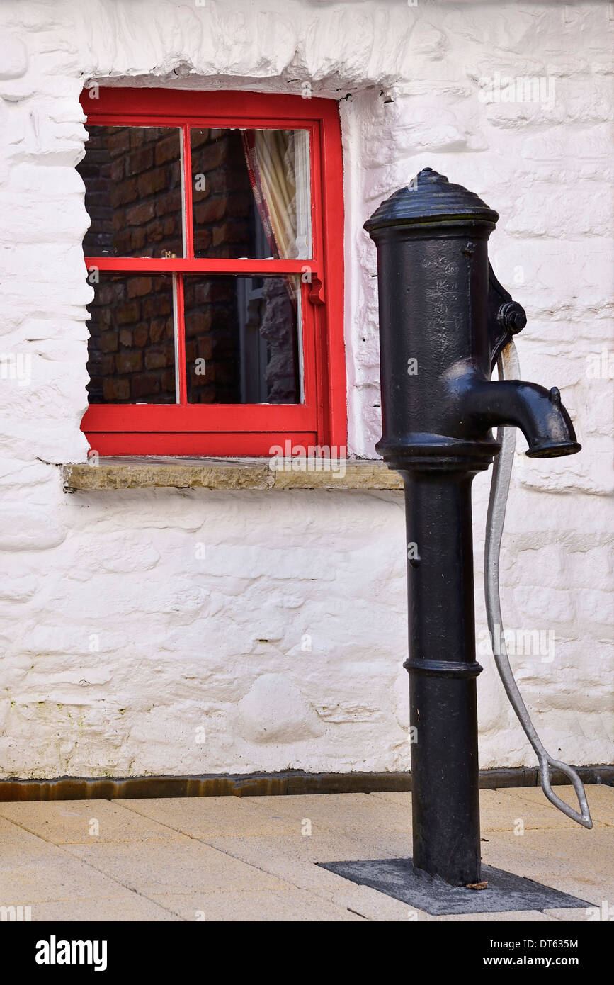Ireland, Derry, Derry Craft Village, Old water pump with small red