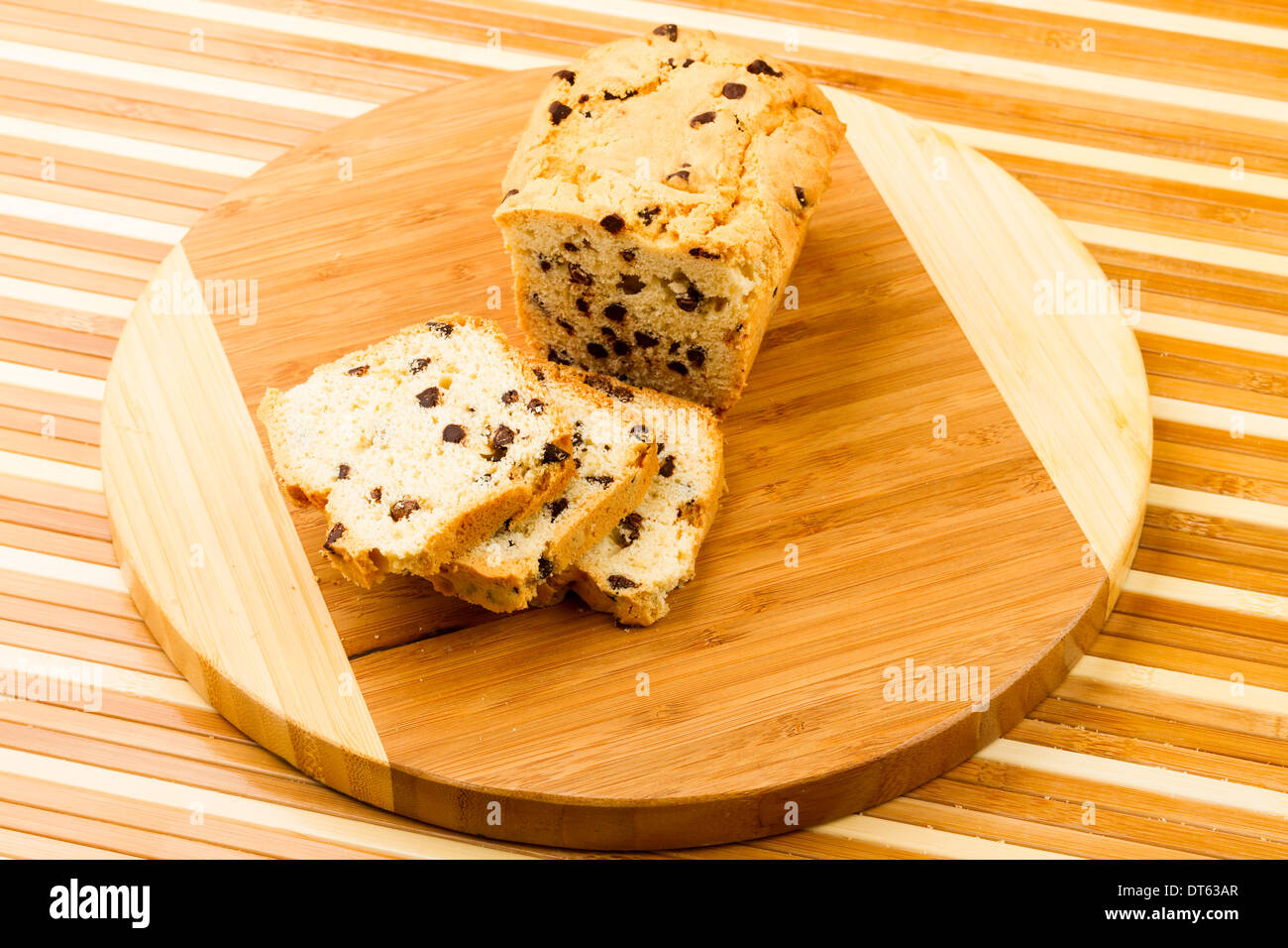 chocolate fruitcake on chopping board Stock Photo