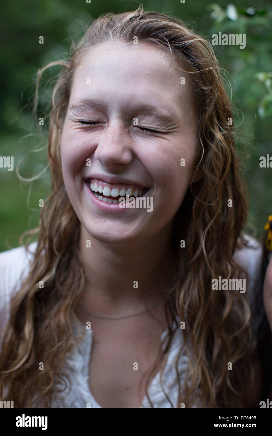 Woman laughing with eyes closed Stock Photo