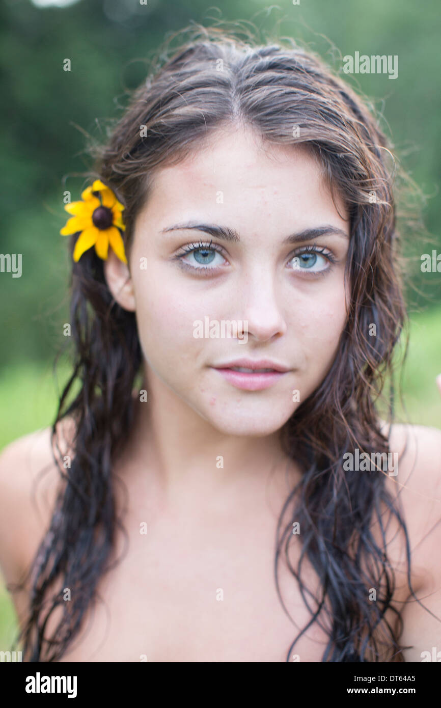 Teenage girl wearing flower in hair Stock Photo Alamy