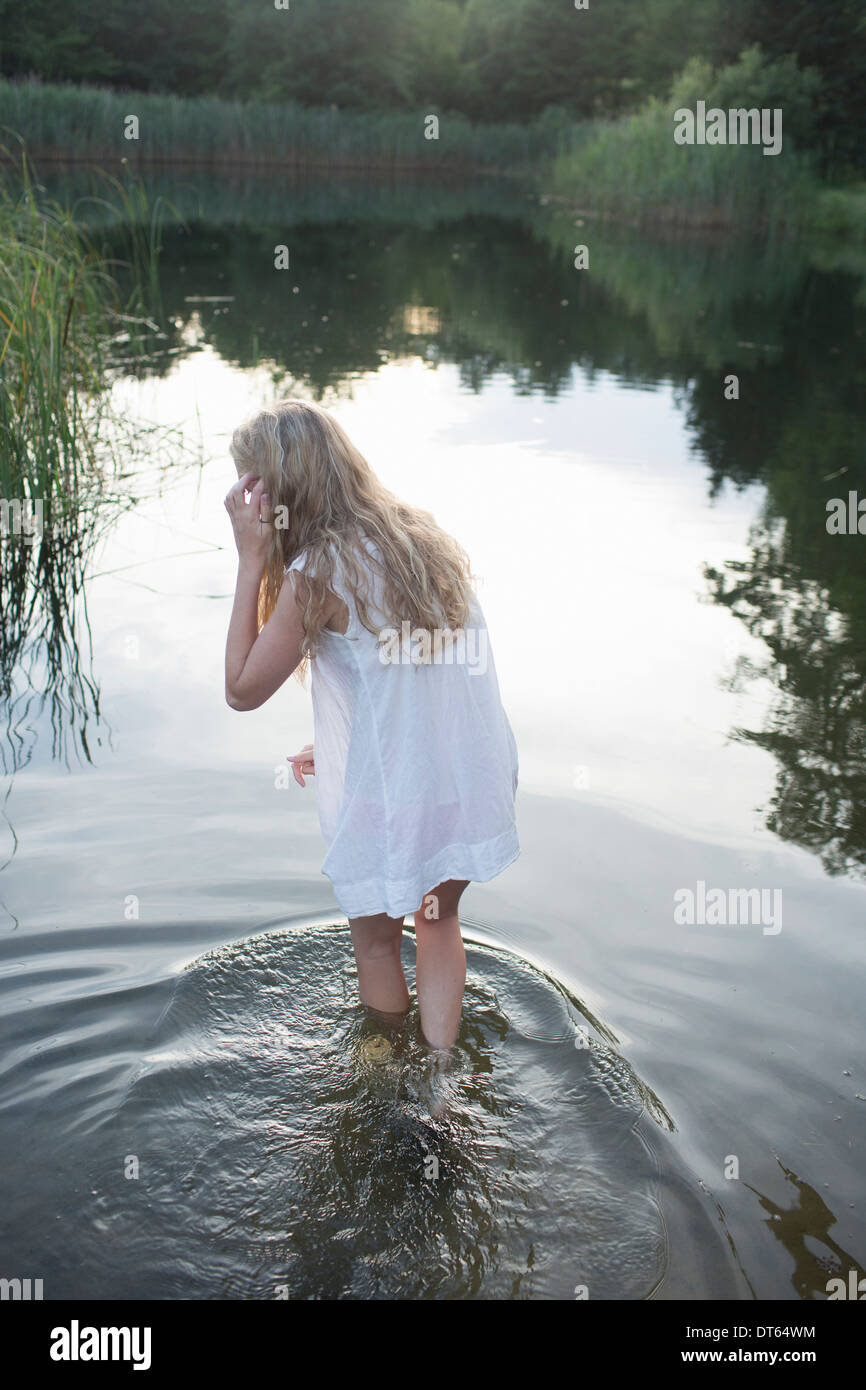 Teenage girl enjoying river in the evening Stock Photo