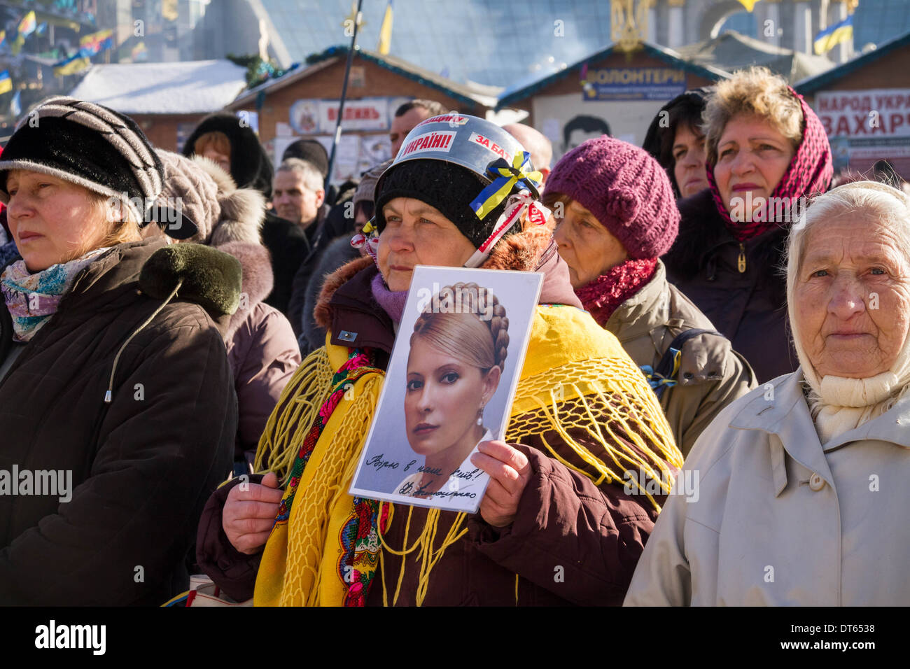 A Euromaidan supporter holds a photo of Yulia Tymoshenko in the crowds by the Euromaidan stage in central Kiev, Ukraine. Stock Photo