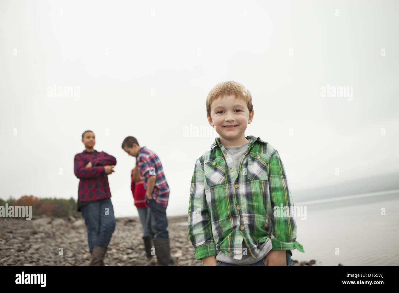 A day out at Ashokan lake. Three teenagers and a young boy on shore. Stock Photo