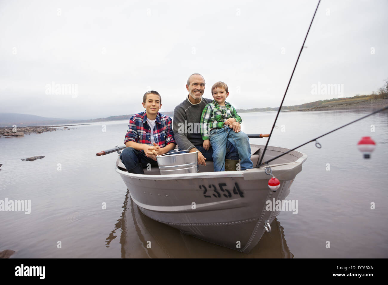 A day out at Ashokan lake. A man and two boys fishing from a boat Stock Photo Alamy