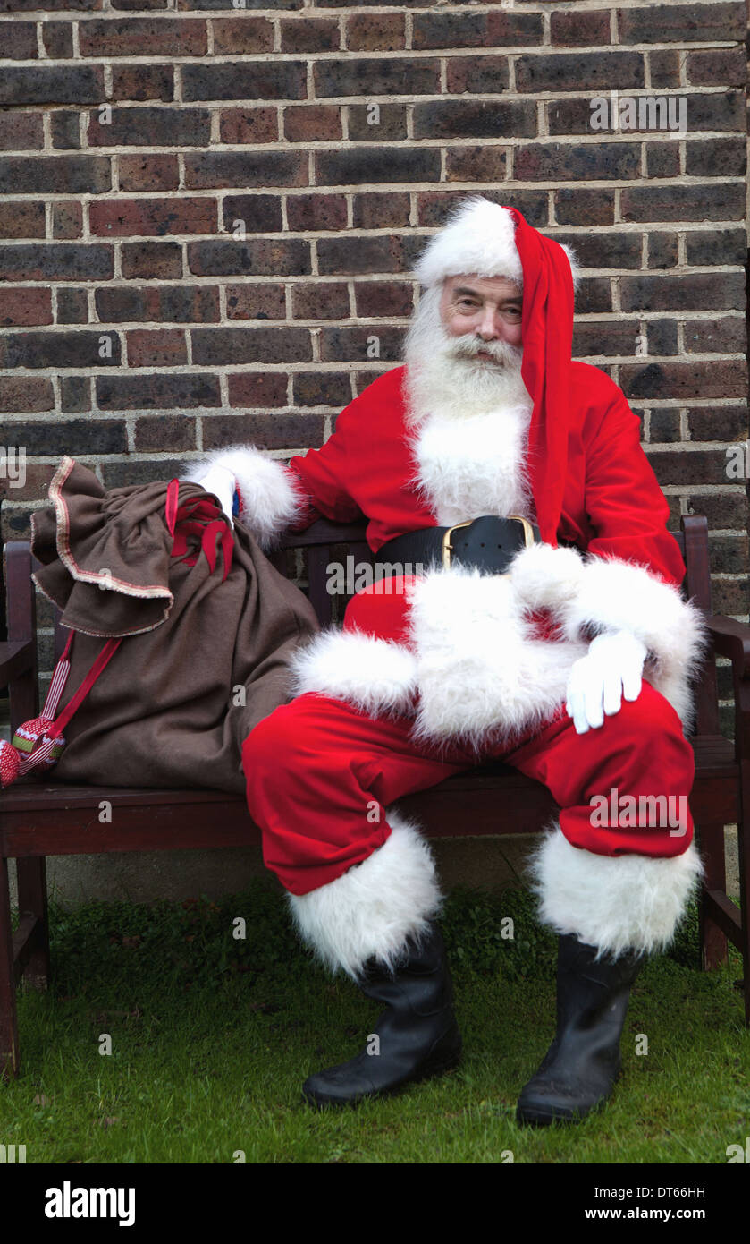 Santa Claus taking break on bench Stock Photo: 66519757 - Alamy