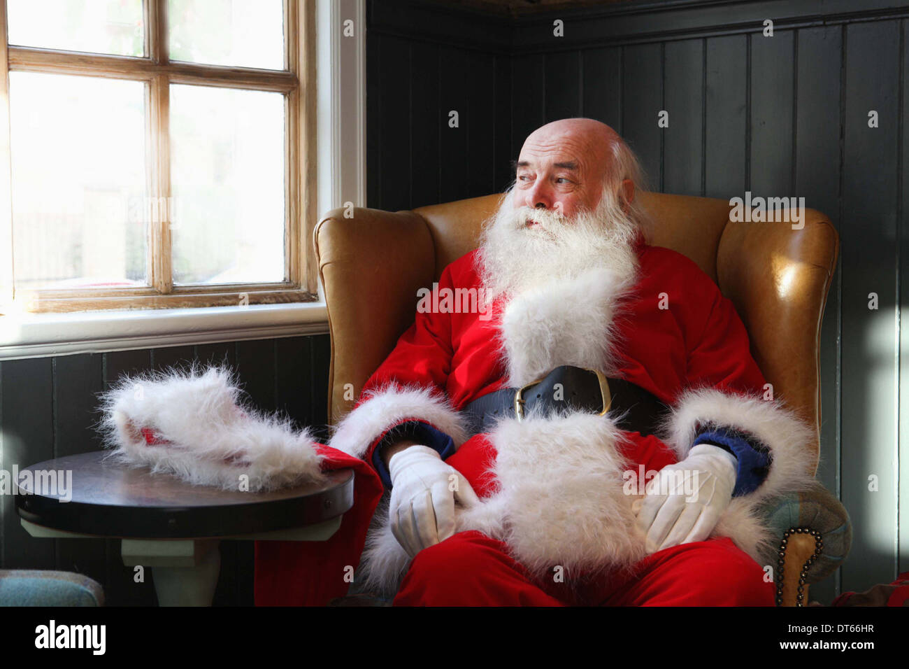 Santa Claus taking break in armchair Stock Photo