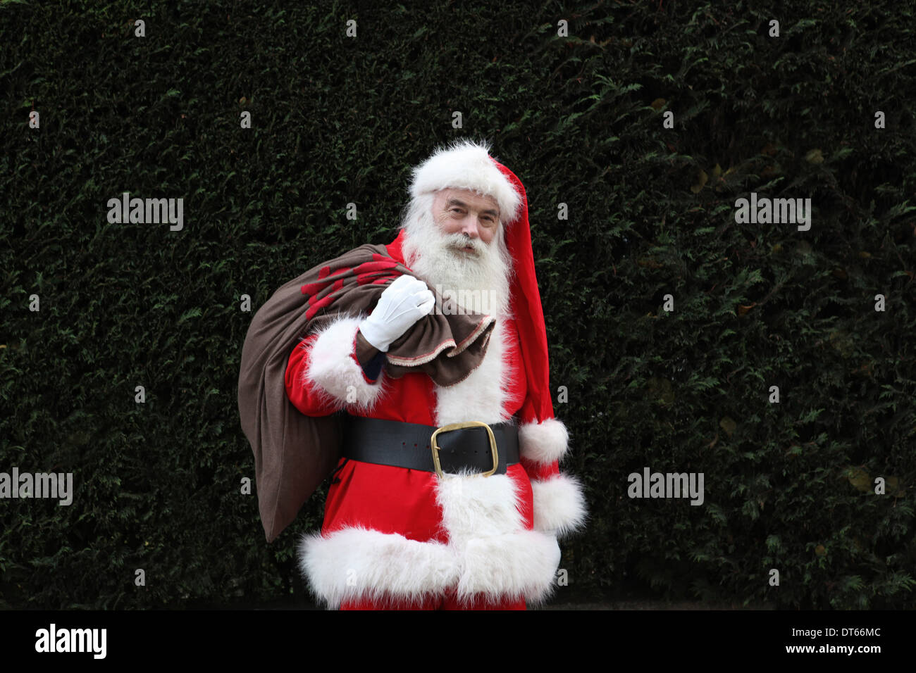 Santa Claus carrying sack over shoulder Stock Photo