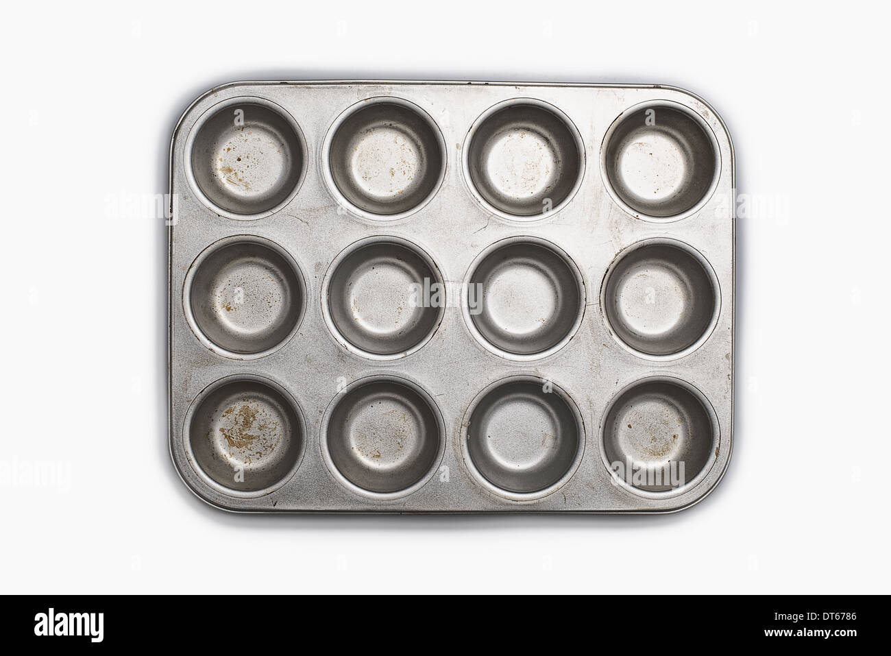 A well used, seasoned baking tray. Cookware.  A cupcake or muffin tin. Stock Photo