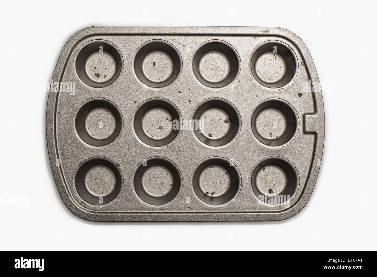 A well used, seasoned baking tray. Cookware.  A cupcake or muffin tin. Stock Photo