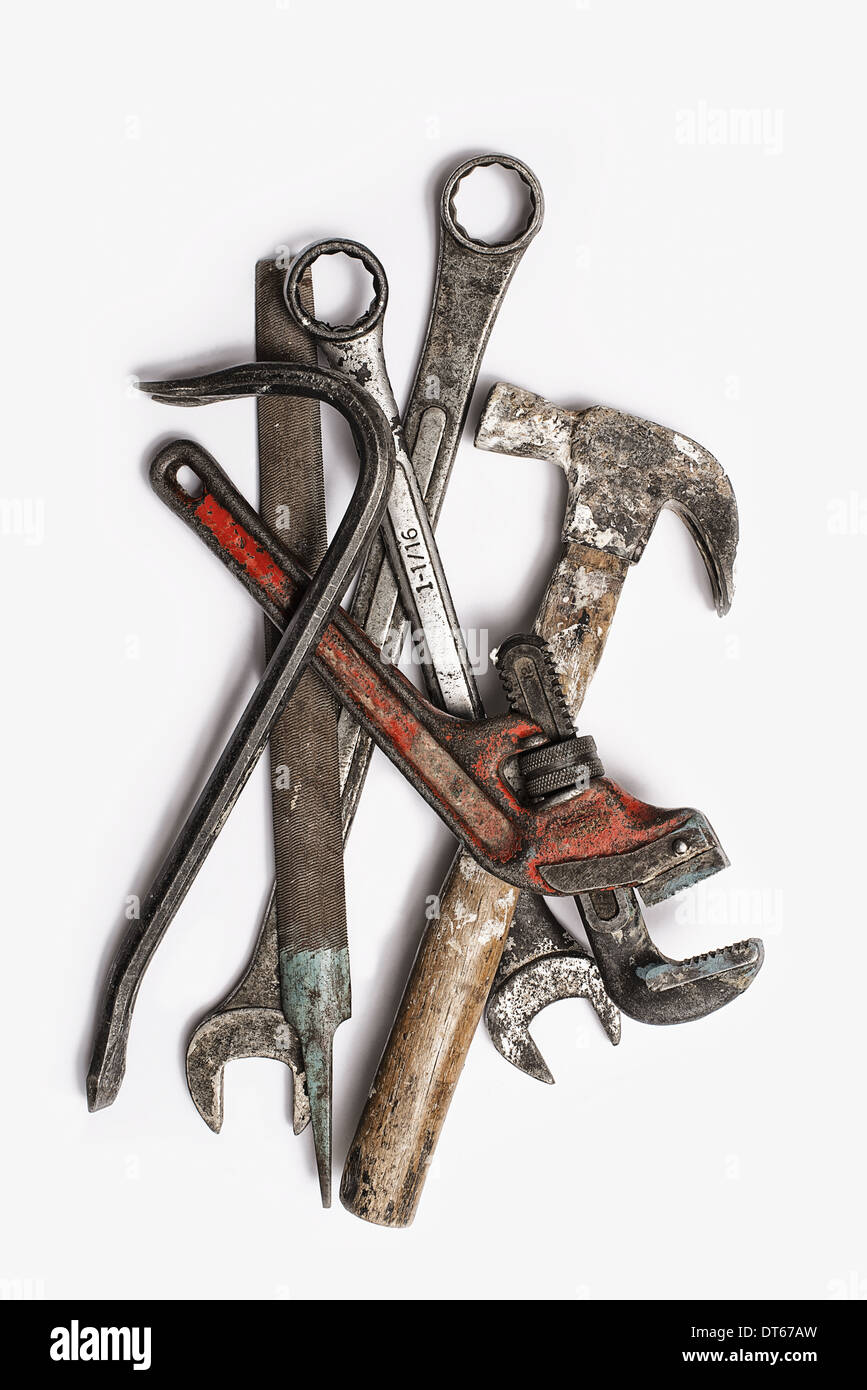Used Tools. A group of spanners, adjustable wrench and hammer. Worn marked metal handheld tools
