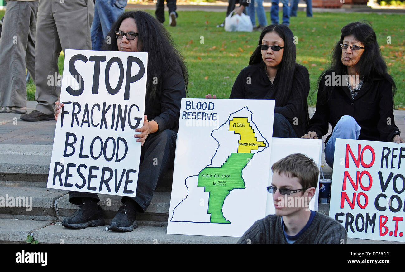Canada, Alberta, Lethbridge, Three Blood Tribe members holding protest signs at anti-fracking demonstration. Stock Photo