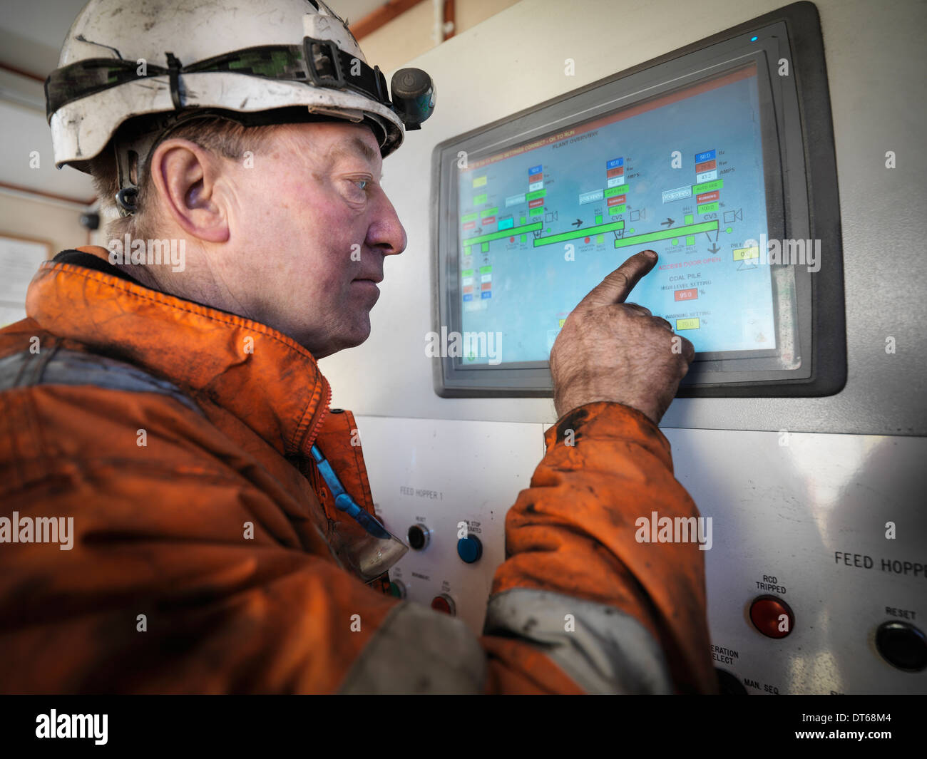 Miner operating process control panel in surface coal mine Stock Photo