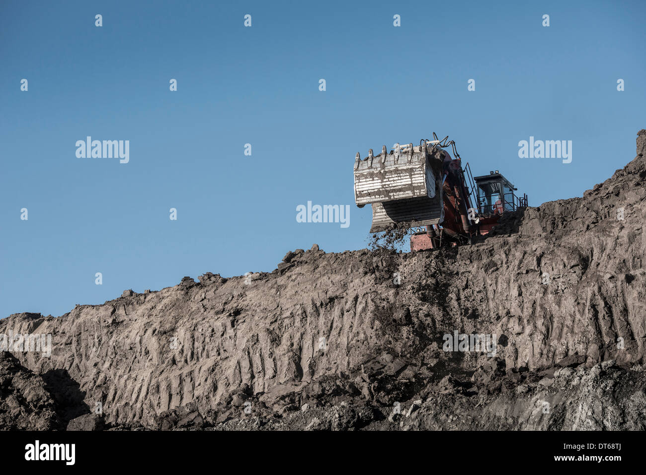 Excavator removes glacial deposits at surface coal mine Stock Photo