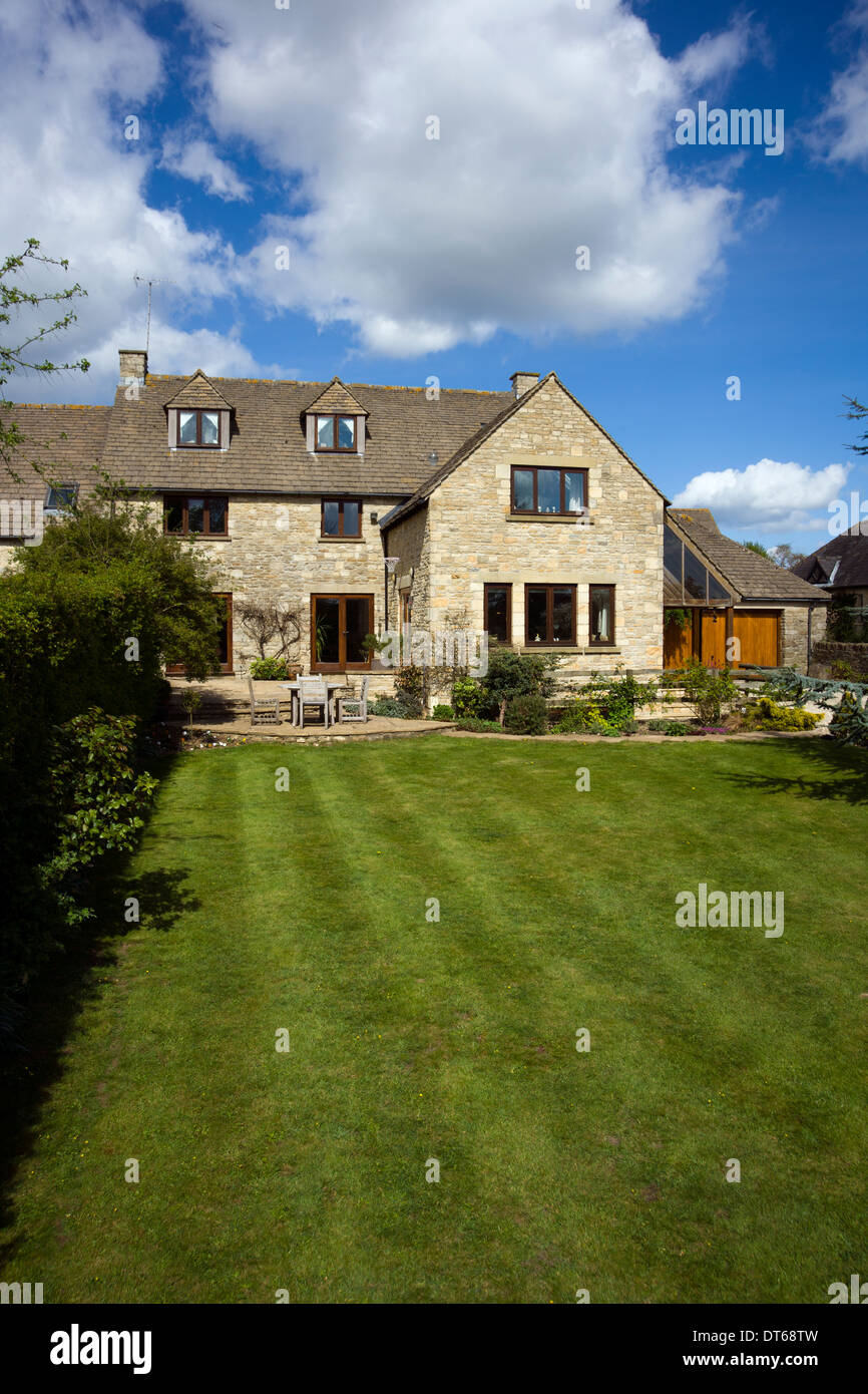 UK gardens. Large lawned garden recently cut with mower stripes Stock