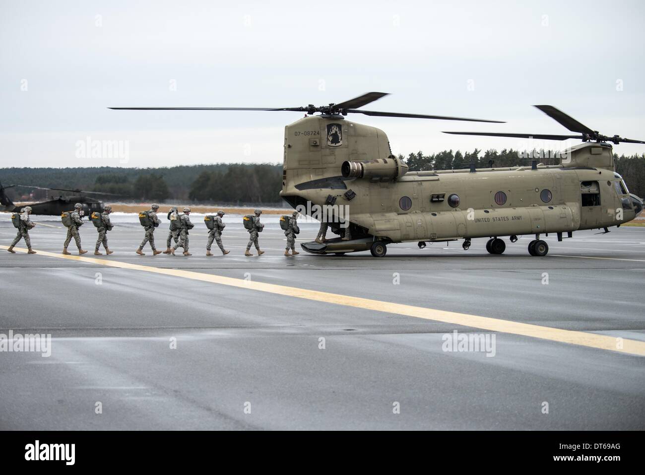 Grafenwoehr, Germany. 10th Feb, 2014. Soldiers of the US Army enter a Boeing CH-47 Chinook helicopter at the training area in Grafenwoehr, Germany, 10 February 2014. About 350 soldiers jumped from about 330 meters above sea level from a military helicopter. The training prepares the 173rd Airborne Brigade for further operations. The unit has already been employed in the war zones in Iraq and Afghanistan. Photo: ARMIN WEIGEL/dpa/Alamy Live News Stock Photo