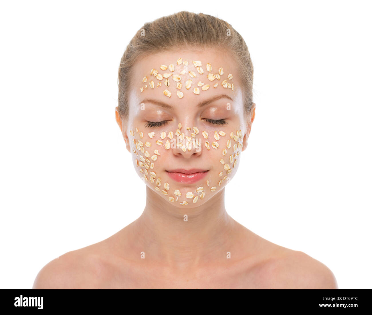 Portrait of relaxed young woman making oatmeal mask Stock Photo