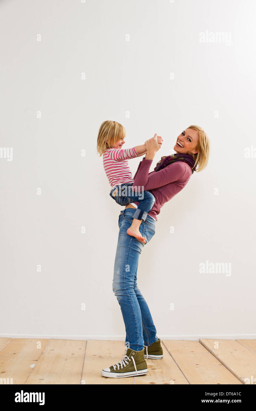 Studio portrait of mother playing with young daughter Stock Photo