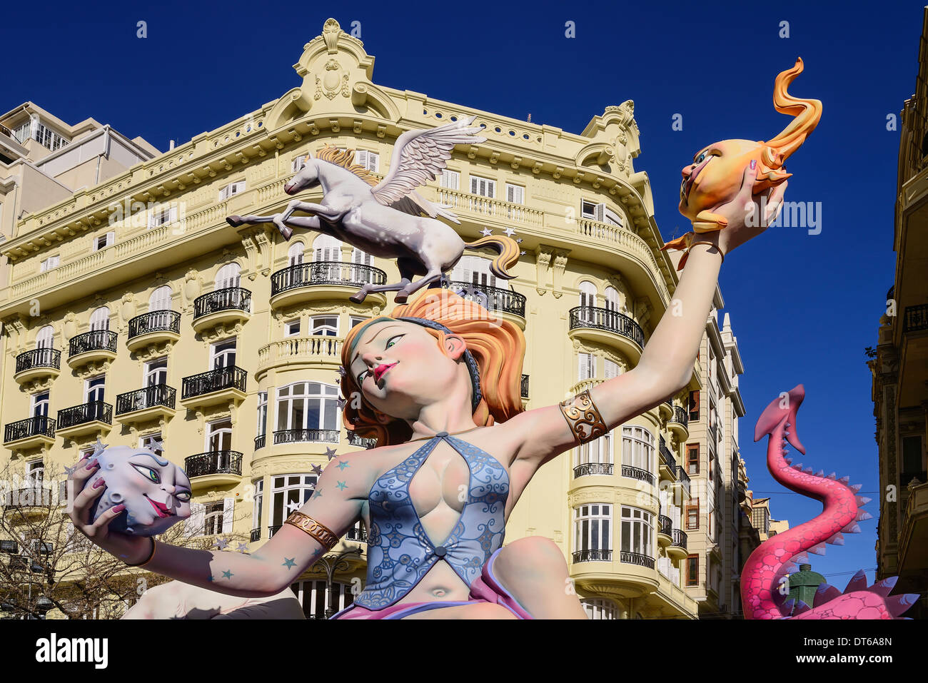 Spain, Valencia, Female Papier Mache figure with a winged horse on her head in the street during Las Fallas festival. Stock Photo