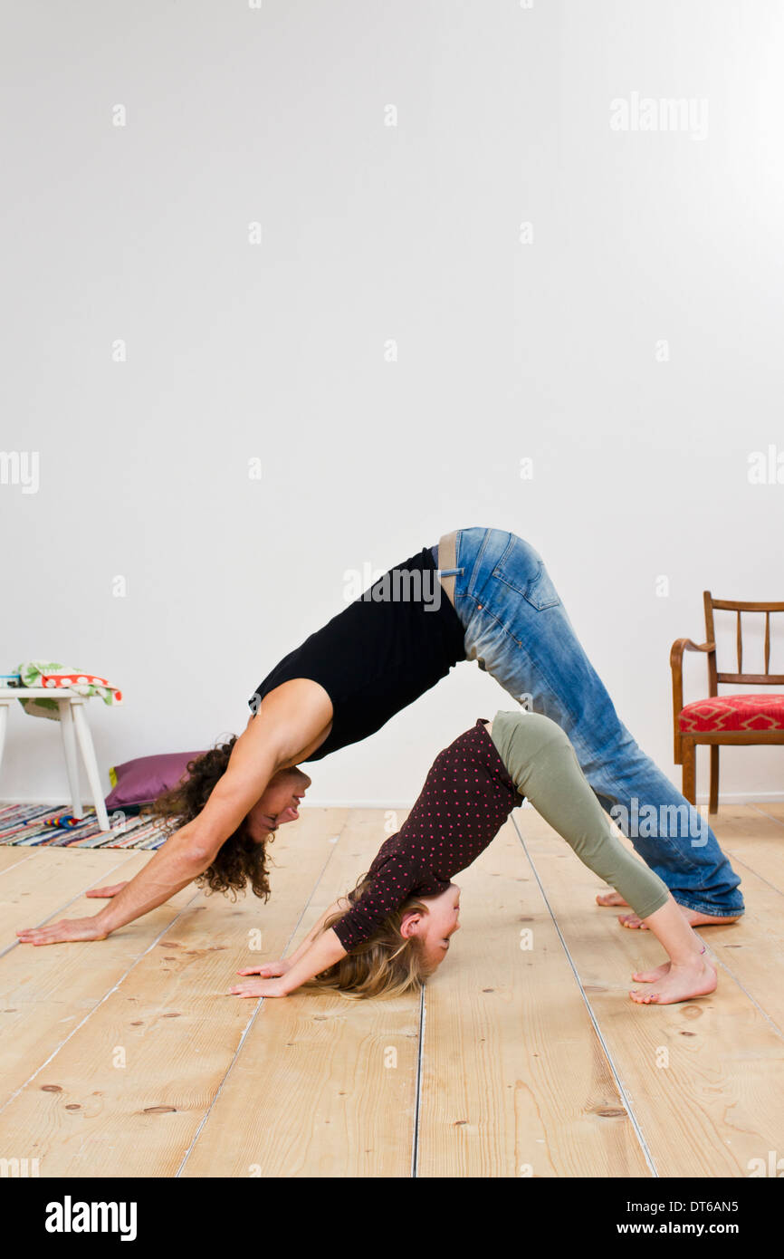 Studio shot of father and daughter bending over on floor Stock Photo
