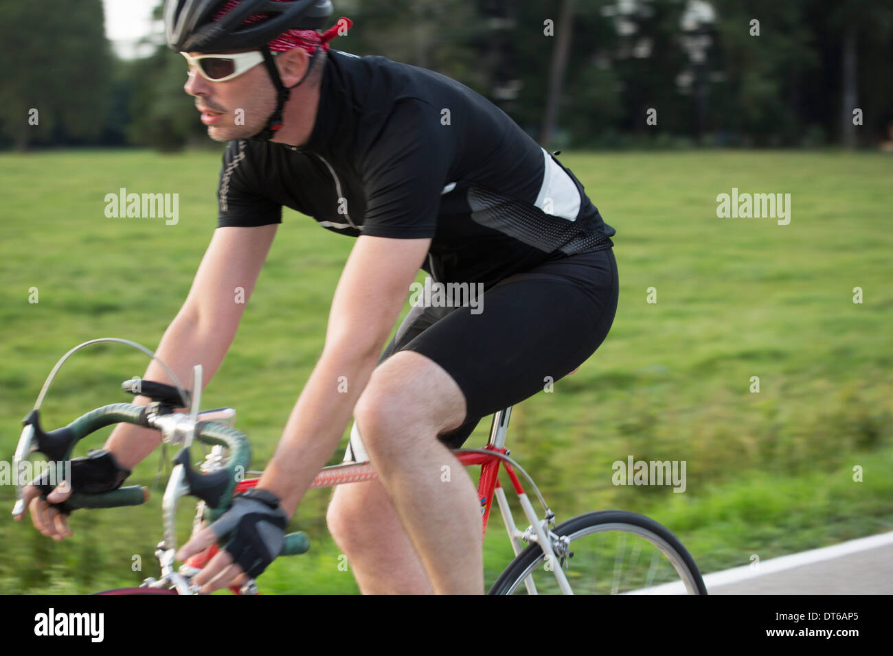 Close up of mature male cycling on country road Stock Photo