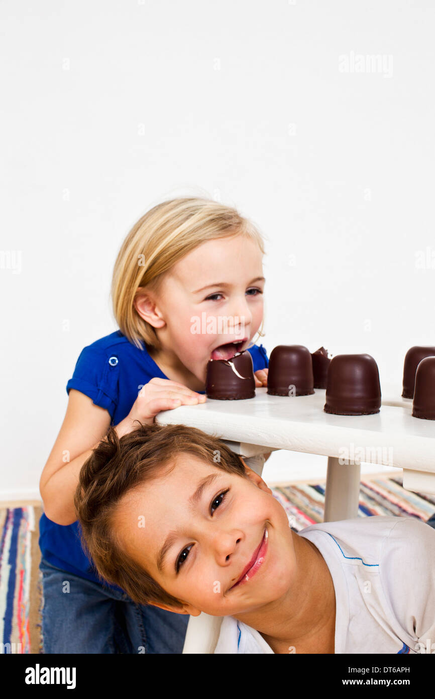 Studio shot of sister and brother with chocolate marshmallows Stock Photo