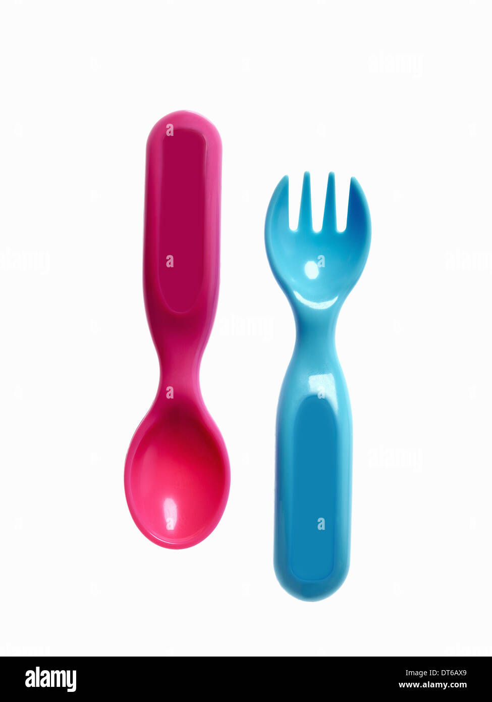 A pink plastic baby spoon and a blue fork Stock Photo Alamy
