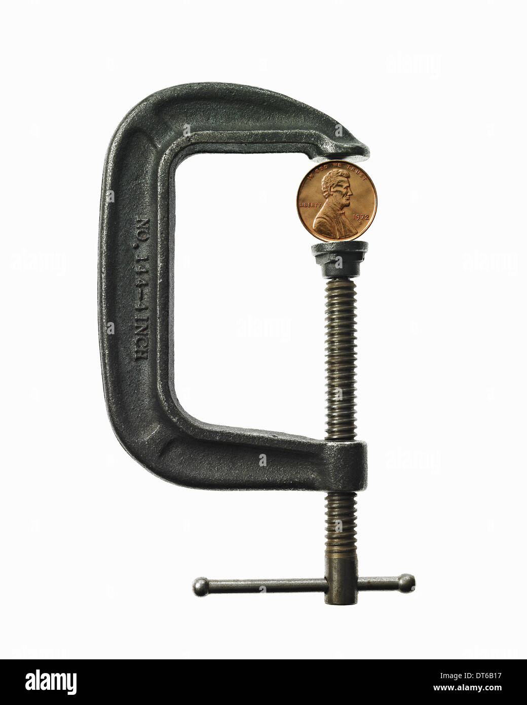 A coin in a clamp. Feeling the pinch, economic squeeze Stock Photo Alamy