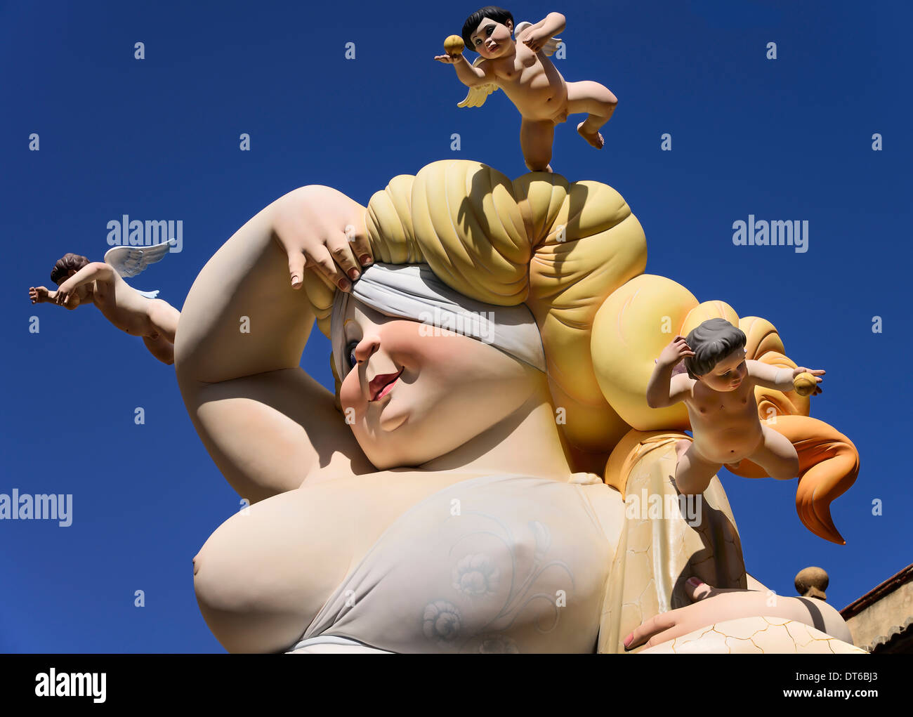 Spain, Valencia, Falla scene with Papier Mache lady and cherubs at Torres de Quart during Las Fallas festival. Stock Photo